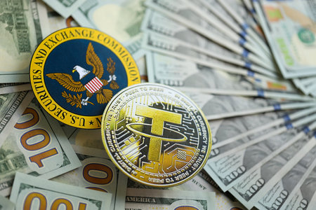 KYIV, UKRAINE - AUGUST 17, 2024 Tether USDT coin and US Securities and Exchange Commission sign on money background close upのeditorial素材