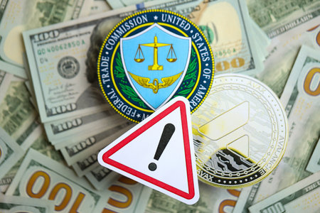 KYIV, UKRAINE - AUGUST 17, 2024 Avalanche AVAX coin and US Federal Trade Commission sign on many USD dollar money bills close upのeditorial素材