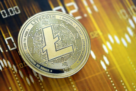 KYIV, UKRAINE - AUGUST 17, 2024 Litecoin LTC coin on dark cryptocurrency digital trading chart in golden yellow colors close upのeditorial素材