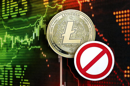 KYIV, UKRAINE - AUGUST 17, 2024 Litecoin LTC coin and red paper prohibition sign on chart background close upのeditorial素材