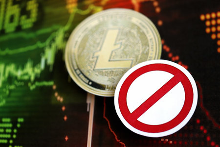 KYIV, UKRAINE - AUGUST 17, 2024 Litecoin LTC coin and red paper prohibition sign on chart background close upのeditorial素材