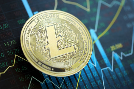 KYIV, UKRAINE - AUGUST 17, 2024 Litecoin LTC coin on abstract fictional candlesticks in trading chart in blue color close upのeditorial素材