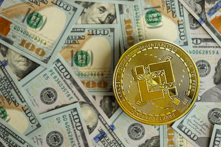 KYIV, UKRAINE - AUGUST 17, 2024 Binance BNB coin on big amount of hundred US dollar bills close upのeditorial素材