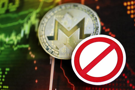 KYIV, UKRAINE - AUGUST 17, 2024 Monero XMR coin and red paper prohibition sign on chart background close upのeditorial素材
