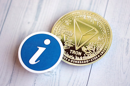 KYIV, UKRAINE - AUGUST 17, 2024 TRON Coin and information sign on wooden background close upのeditorial素材