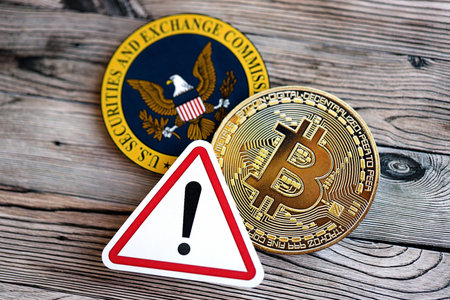 KYIV, UKRAINE - AUGUST 17, 2024 Bitcoin BTC coin and red paper attention sign with Securities and Exchange Commission on wooden background close upのeditorial素材