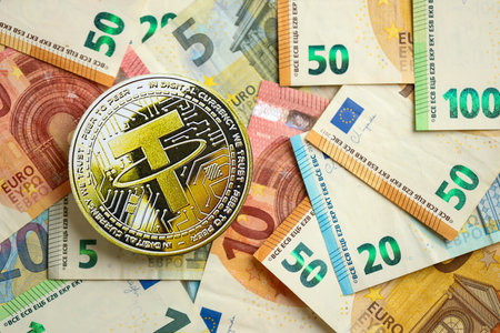 KYIV, UKRAINE - AUGUST 17, 2024 Tether USDT coin with big amount of european euro bills close upのeditorial素材