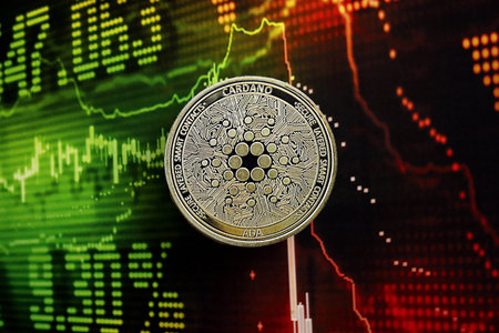 KYIV, UKRAINE - AUGUST 17, 2024 Cardano ADA coin on dark cryptocurrency digital trading chart in green and red colors close upのeditorial素材