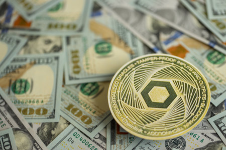 KYIV, UKRAINE - AUGUST 17, 2024 Chainlink LINK coin on big amount of hundred US dollar bills close upのeditorial素材
