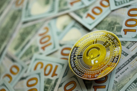 KYIV, UKRAINE - AUGUST 17, 2024 PolkaDot coin on big amount of hundred US dollar bills close upのeditorial素材