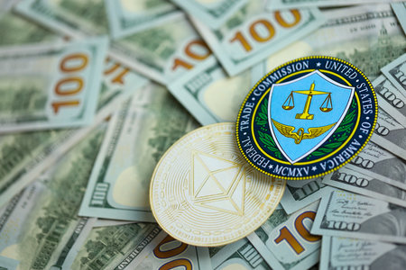 KYIV, UKRAINE - AUGUST 17, 2024 Ethereum ETH coin and US Federal Trade Commission sign on many USD dollar money bills close upのeditorial素材