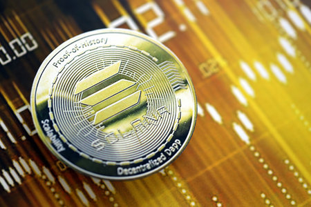 KYIV, UKRAINE - AUGUST 17, 2024 Solana SOL coin on dark cryptocurrency digital trading chart in golden yellow colors close upのeditorial素材
