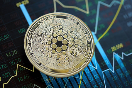 KYIV, UKRAINE - AUGUST 17, 2024 Cardano ADA coin on abstract fictional candlesticks in trading chart in blue color close upのeditorial素材