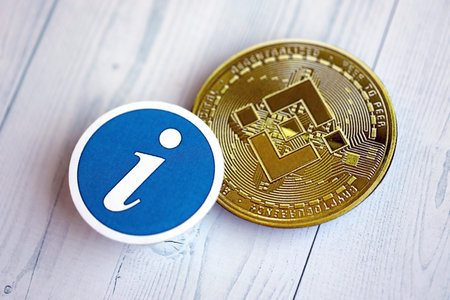 KYIV, UKRAINE - AUGUST 17, 2024 Binance BNB coin and information sign on wooden background close upのeditorial素材
