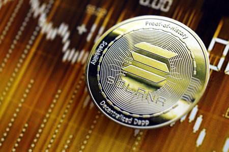 KYIV, UKRAINE - AUGUST 17, 2024 Solana SOL coin on dark cryptocurrency digital trading chart in golden yellow colors close upのeditorial素材
