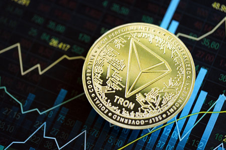 KYIV, UKRAINE - AUGUST 17, 2024 TRON Coin on abstract fictional candlesticks in trading chart in blue color close upのeditorial素材