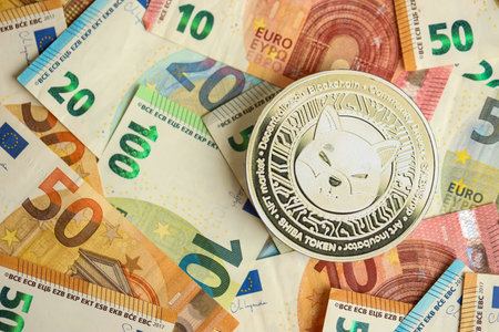 KYIV, UKRAINE - AUGUST 17, 2024 Shiba coin with big amount of european euro bills close upのeditorial素材