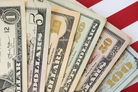 American US dollars money bills and on American flag close up. Money investment concept and...