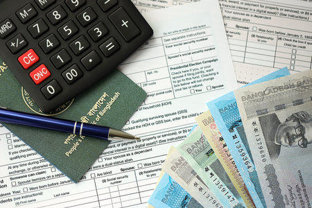 Bangladeshi taka money bills in big amount lies on table with pen, calculator, passport and tax forms close up. Finance and banking conceptの写真素材