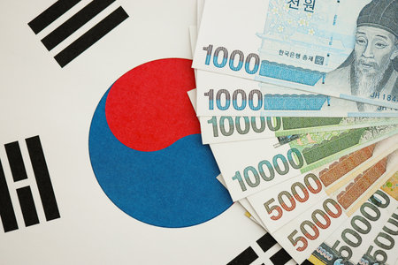South Korean won money bills in big amount lies on South Korea flag close up. Finance and banking conceptの写真素材