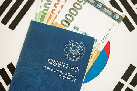 South Korean won money bills in big amount and passport lies on South Korea flag close up. Finance and banking conceptの写真素材