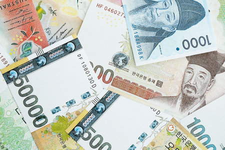 South Korean won money bills in big amount lies on white color table close up. Finance and banking...