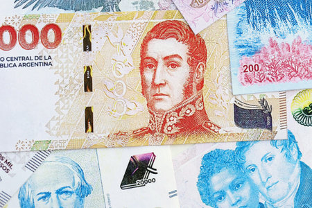 Argentine pesos money bills in big amount lies on white table close up. Finance and banking conceptの写真素材