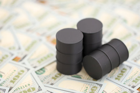 Barrels of oil on bills of American dollars. purchase, sale of oil concept close upの写真素材