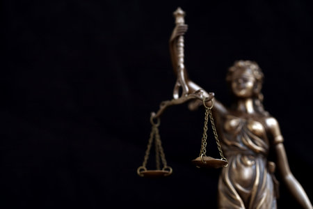 Lady Justice dark statue in law on black backdrop. Law and justice concept
