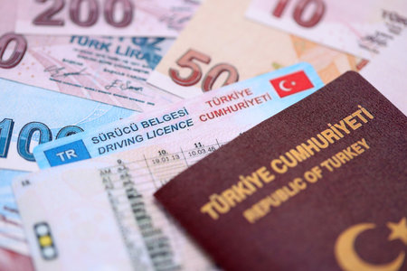 Turkiye driving permit concept. Driver license with passport and turkish liras money bills close upの写真素材