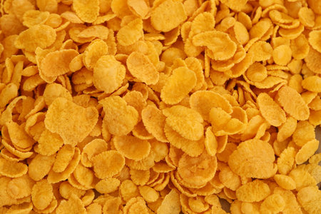 Corn flakes background close up. Top view cornflake cereal box for morning breakfast