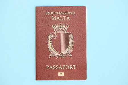 Malta passport on light blue paper background close up. Citizenship and travel in Europe conceptの写真素材