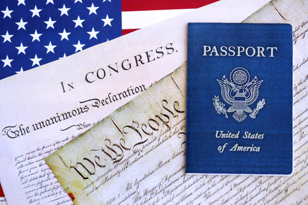 Preamble to the Constitution of the United States with passport and American Flag. Old yellow paper with We The People textの写真素材