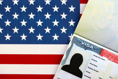 United States flag and United States visa. Concept of Immigration and Travel to the United States. Visa in the passport on the background of the American flagの写真素材