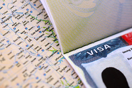 Visa to USA and trip to United States. Visa sign with background United States map close upの写真素材