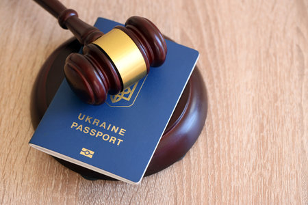 Judge gavel and ukrainian passport on brown background. Passport Of Ukraine. Obtain citizenshipの写真素材