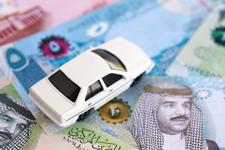 Bahraini dinar currency money bills and toy car close up. The concept of car ownershipの写真素材