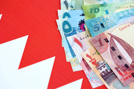 Bahraini dinar currency money bills lies on flag close up. The concept of business and investment
