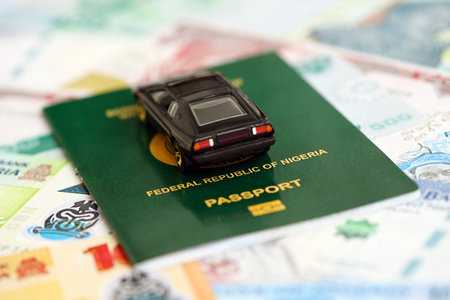 Nigerian naira currency money bills and car with passport close up. The concept of car ownershipの写真素材