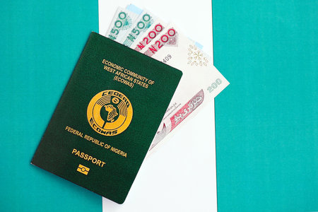 Nigerian naira currency money bills and passport lies on flag close up. The concept of travel and vacationの写真素材