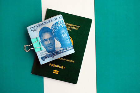 Nigerian naira currency money bills and passport lies on flag close up. The concept of travel and vacationの写真素材
