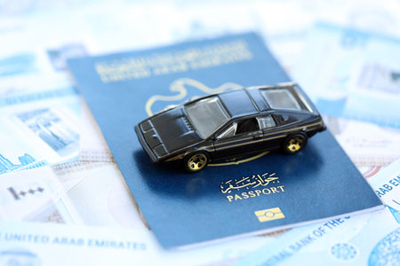 United Arab Emirates dirham currency money bills and car with passport close up. The concept of car ownershipの写真素材