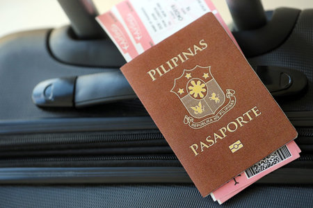 Philippines passport and avia tickets on travel bag close up. The concept of travel and vacationの写真素材