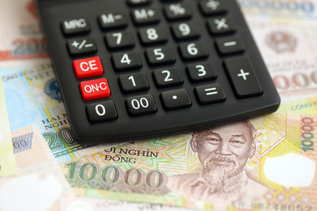 Vietnamese dong currency money bills and calculator close up. The concept of taxation and money countの写真素材