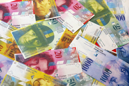 Swiss franc banknotes. The current francs money bills lies on table in big amount. The concept of...
