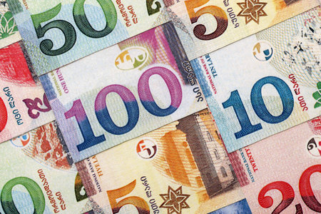 Georgian Lari currency money bills in heap. GEL currency banknotes with different denomination close...