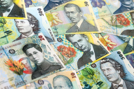 Romanian Leu currency money bills. RON currency banknotes in heap with different denomination close...