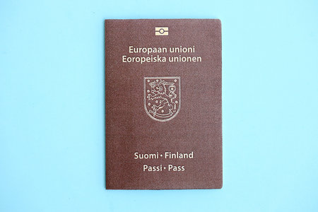 Finland passport on light blue paper background close up. Citizenship and travel in Europe conceptの写真素材