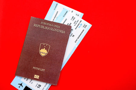 Slovenia passport and commercial airlines boarding pass tickets close up. Travel flights and avia tourism in Europe conceptの写真素材