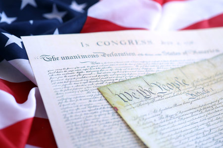 Aged historical documents Washington DC on American Declaration of independence 4th july 1776 on U.S. flag close upの写真素材